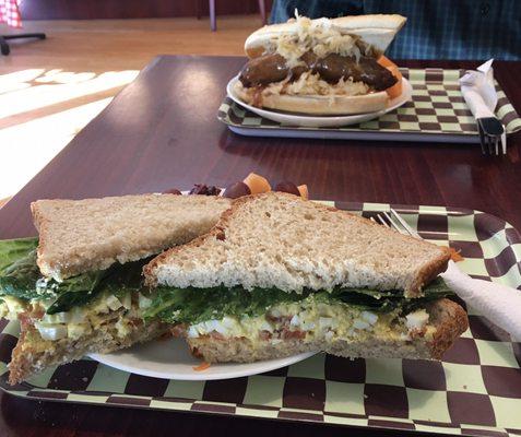 Egg salad sandwich on homemade rye. Bratwurst & sauerkraut on a hoagie.