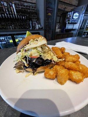 Smoked Korean bbq sandwich with spicy apple coleslaw,drizzled with black garlic Bulgogi sauce and a pleasant side of Taters!!!