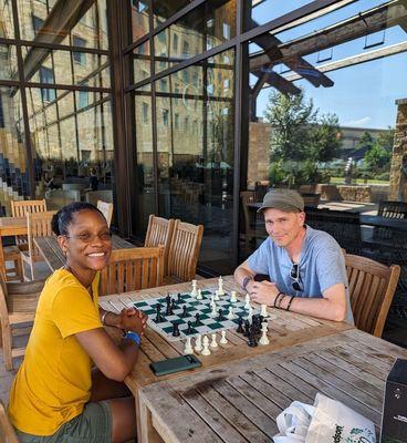 Enjoying the giant shaded back porch with a friendly chess opponent. (I brought my own set.)