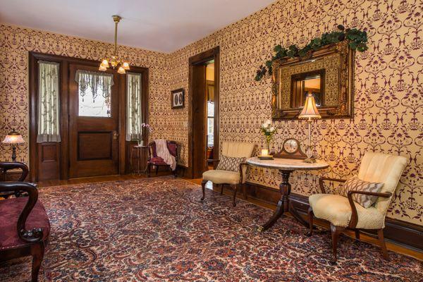 The spacious foyer features a split staircase going up to four of the guestrooms.