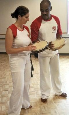 Student learning pandeiro (capoeira music) with Mestre Bomba