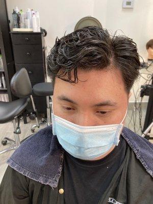 Wave perm at about a 70/30 split from natural side part