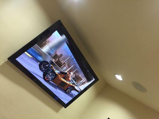 Huge flat screen television playing movies while the kids wait to see the dentist