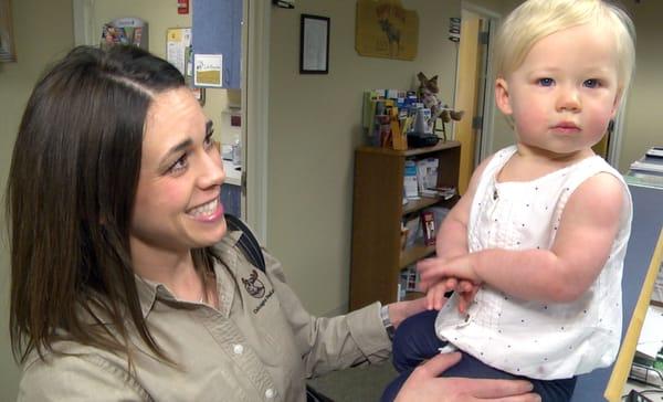 Kristen just finishes a check-up on a baby girl who's sizing up our office.