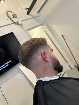 Mid bald fade with a beard blend and trim on top -John