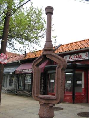 the storefront (as seen through the outline of a missing call box)