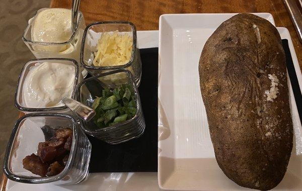 Loaded baked potato comes with cheese, bacon, butter sour cream and chives.