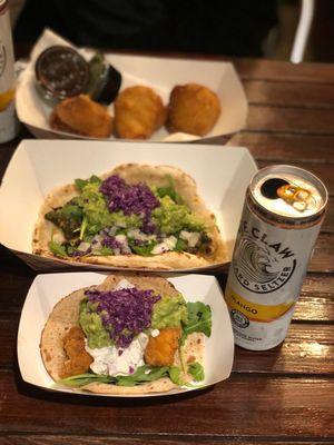 SALMON PAKORA roti taco (front); Saag Paneer naan taco (top)