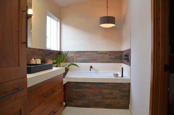 Contemporary bath with slate tile and milk bath