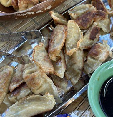 Fried Pork Dumplings & a soy sauce-based dipping sauce.