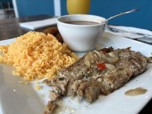 Lechon with yellow rice and beans. ( we couldn't help it and took a bit before the picture was taken lol).