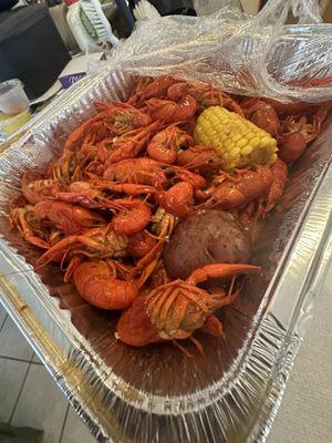 4lb of spicy crawfish to go! Two pans included two large potatoes, two corn and two decent sized pieces of sausage. Delicious.