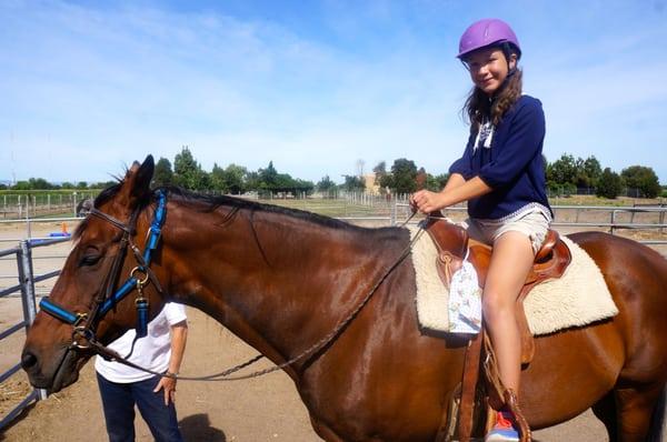 Caeley all smiles on a horse.