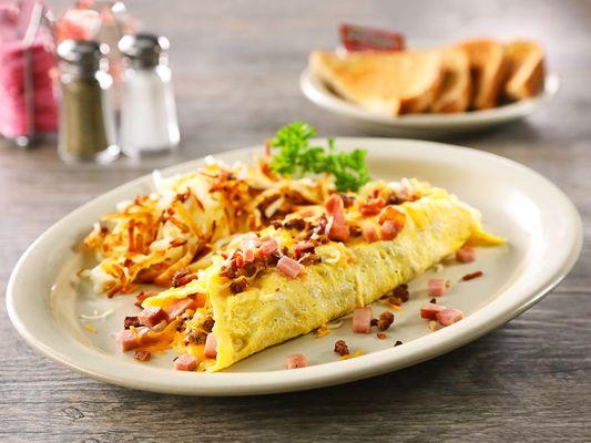 Texas Omelet - Stuffed with bacon, sausage, diced ham and American cheese. Then topped with Cheddar and Monterey Jack cheese.