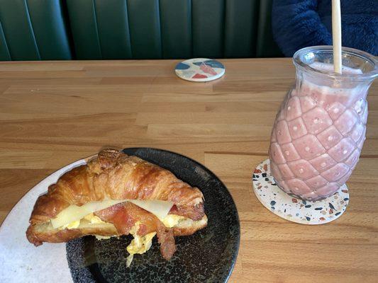 Bacon Egg & Cheese Sandwich on a croissant Creamy Smoothie with oat milk