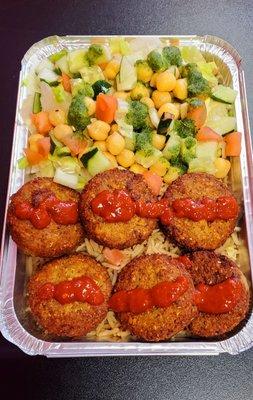 Falafel over rice, with chick peas, salad, tomato and cucumber. Green sauce goes good on the salad. Always fresh and delicious here.