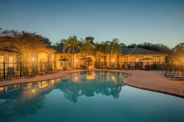 Resort-style swimming pool at dusk