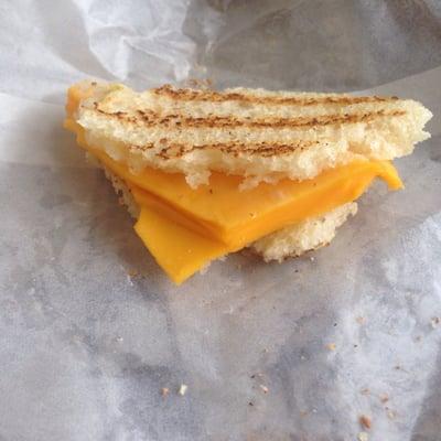 A wad of craft cheese not melted on panini bread.