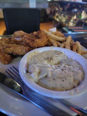 Cold fries, terrible tasting chicken strips, and some off white stuff.