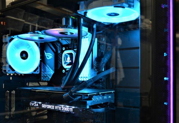 Gaming PC assembly with Corsair liquid cooling system.