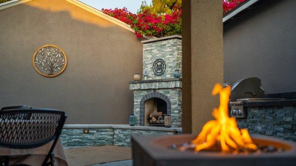 Backyard Oasis. Fireplace, outdoor kitchen, pavers, artificial turf, LED lighting, and beautiful plant selection.