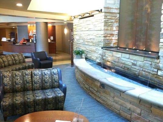 A large relaxing space with waterfall and service desk just inside the north entrance.