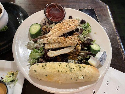 Grilled Chicken Breast salad with a massive breadstick.