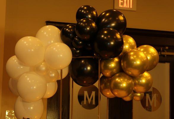 Added some white, black & gold balloon centerpieces and backdrop to Maggiano's Private space for a 70th Bday Party. Elegant, Cute & Quick!!!