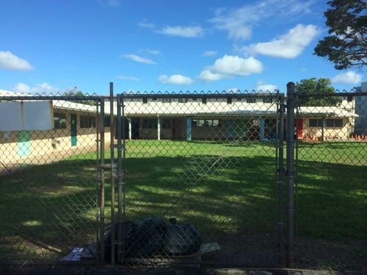 Pic of the school from the parking lot that has a huge play area for the kids. It also doubles as an assembly area during events