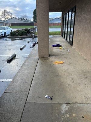 Front of business and entry door. There's fingerprints on the windows and the blinds are broken and dirty.