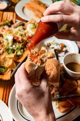 Crystal hot sauce on a fried shrimp po boy.