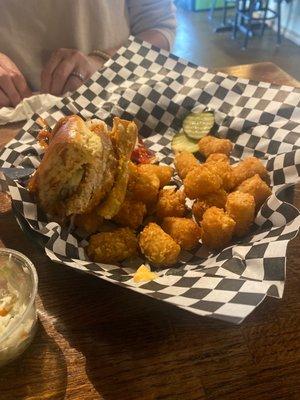 Southern Crispy Fried Chicken Sandwich with tater tots. Tots come with a delicious cheese sauce!