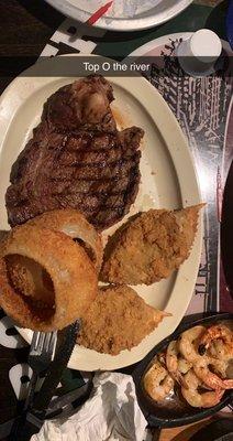 Ribeye Steak, fried crab cakes, onion rings & shrimp scampi