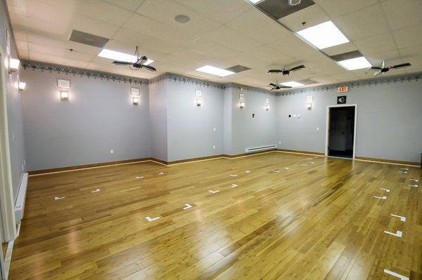 Studio space. Classes are practiced without the overhead fluorescent lights. Wall lights are also dimmable.