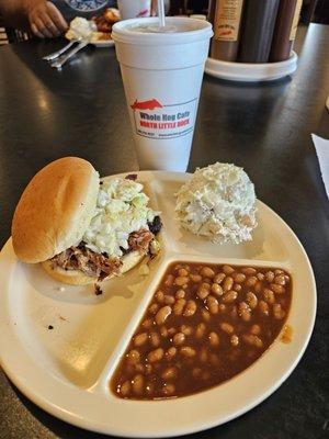 Pulled pork sandwich with potato salad and baked beans