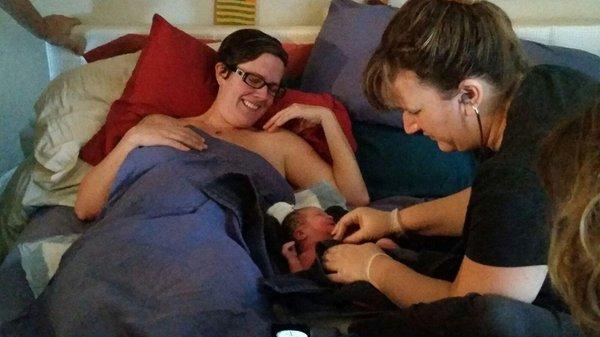 Rose, one of the student midwives, with me and my baby shortly after birth.