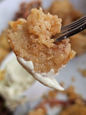 Close-up of a piece of the Fried Calamari appetizer on a fork.