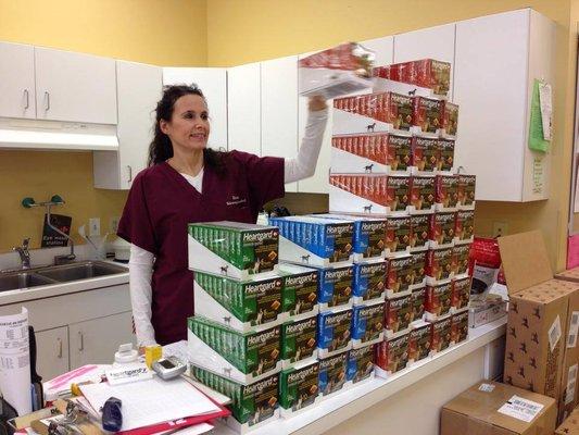 Sharon stacks boxes of Heartgard, get ready for mosquito season!