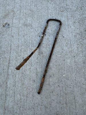 One of several rusty metal spikes I have found since service. Not safe for dogs or children!!