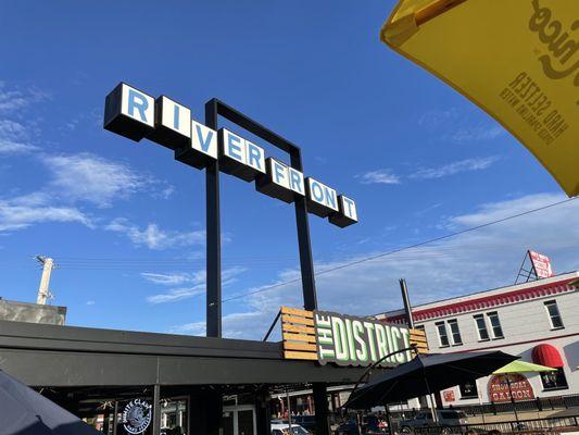 View of Riverside and The District signs.