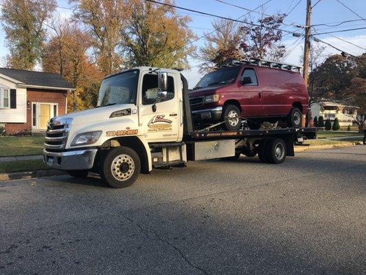 Springfield Virginia Tow Truck. Flatbed towing a commercial van