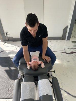 Dr. Otis Perkins with 7 day old, making sure her nervous system is fully functional in this vital time of growth