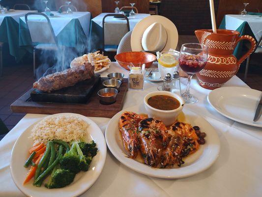 See the steak sizzling on the stone! Look at those giant prawns with the sauce!