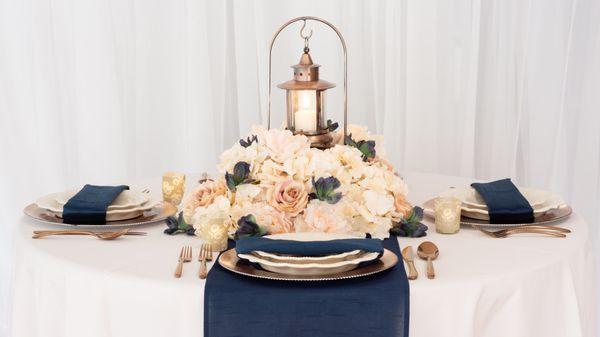 We're in love with this light pink and navy palette featuring a polyester tablecloth with shantung silk napkins and runner.