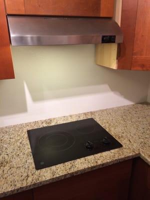 New custom granite counter installation including under mount sink and the inset cooktop pictures here.