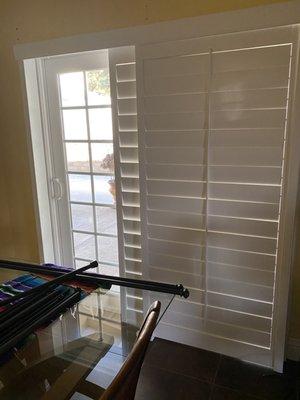 The shutters slide for access to open or close patio door.