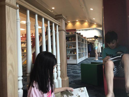 The kids found a cozy place to look through books!