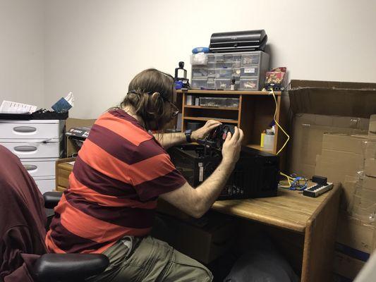 Scott Larson is installing a 3D gaming graphics card.