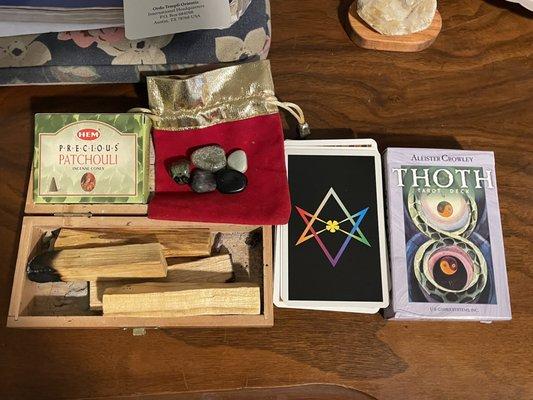 Palo santo sticks, droop cones, crystals, and THOT tarot card deck (78 cards)