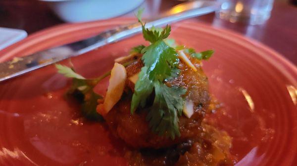 Albondigas: Three lamb meatballs, tomato sauce, sliced 
 almonds and cilantro (one of 3)